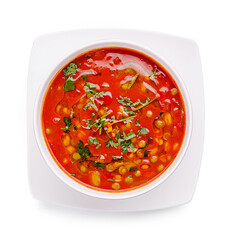 Freshly prepared tomato soup garnished with herbs and spices