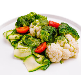 Fresh vegetable salad with greens and cherry tomatoes on a plate