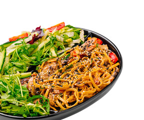 Delicious vegetable and noodle dish served in a black bowl