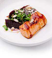 Grilled salmon fillet served with fresh salad and almonds