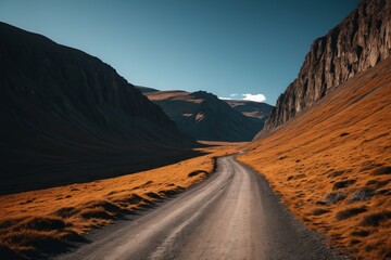 Fototapeta premium dirt road in the middle of a mountain with a mountain in the background
