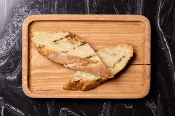 Artisan Biscotti arranged beautifully on a Wooden Plate set against a Dark Background