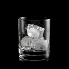 Whiskey glass with three ice cubes inside on black background, studio shot