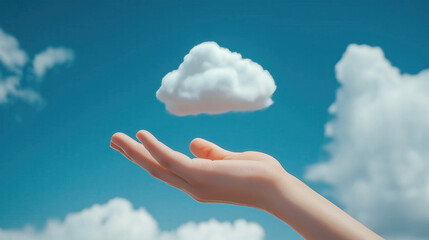 Hand Reaching for a Floating Cloud Against a Blue Sky Background