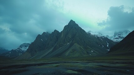 Majestic Mountain Landscape Under Cloudy Sky in Remote Wilderness