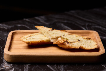 Artisan Biscotti arranged beautifully on a Wooden Plate set against a Dark Background