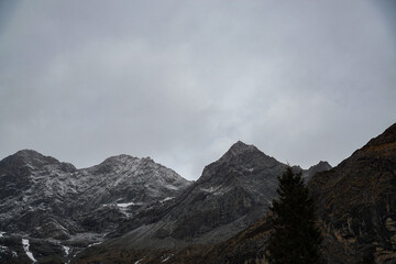 Obraz premium Mountain peaks in overcast sky alpine region nature photography dramatic landscape wide angle adventure exploration