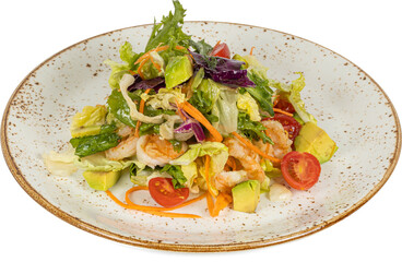 A salad with shrimp and creamy avocado served on a white plate