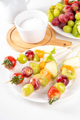 Traditional Chinese sweet street food recipe Tanghulu, fruit skewer on stick with crunchy sugar glaze, easy healthy dessert. Step by step preparation of Tanghulu with ingredients on table, top view