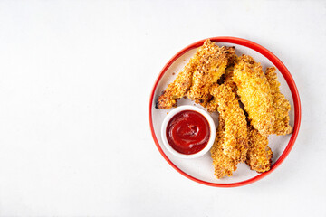 Tasty flavorful freshly cooked chicken nuggets or strips, with golden corn breading, fried in less oil. Homemade balanced diet fast food alternative