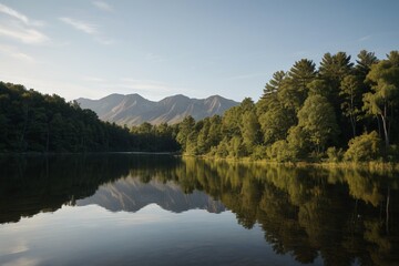 Fototapeta premium trees are reflected in the water of a lake with mountains in the background
