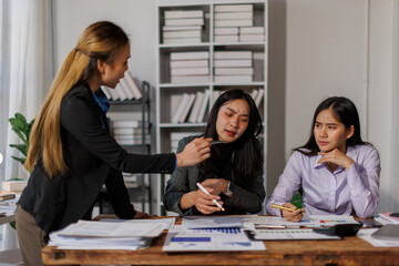 Stressed annoyed office employee manager having headache migraine at business meeting with colleagues about business problem they have to solve. Stress at work or migraine concept.
