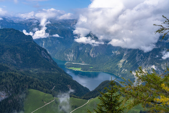 Aerial panorama view of the Koenigssee Lake and the Alps of Berchtesgadener Land from top of Jenner peak on a sunny summer day with blue sky and cloud, Bavaria, Germany