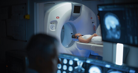 In Medical Laboratory Patient Undergoes MRI or CT Scan Process, in Control Room Doctor Watches...