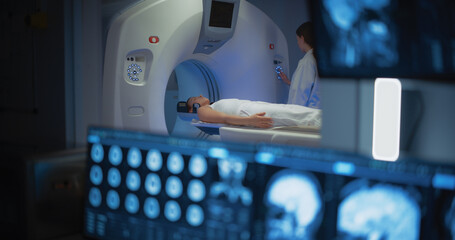 Medical Hospital Research Lab: Male Medical Scientist Using Computer with Brain Scan MRI Images of...