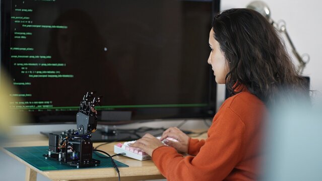 Hispanic Coder's Digital Workspace.A Hispanic software developer immersed in research, coding, and problem-solving, emphasizing the blend of culture and technology.	