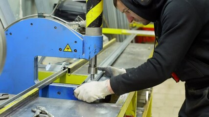 Industrial Engineer Operating a Powerful Press Machine to Join Two Heavy Metal Pieces in a High-Tech Manufacturing Factory. High quality 4k footage