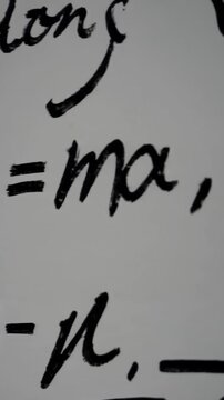Dynamic display of physics formulas in motion on a whiteboard canvas