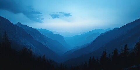 Obraz premium Majestic silhouette of misty mountains under a vivid azure sky. Ethereal clouds dance above, casting delicate shadows over the peaks