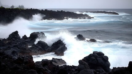 Fototapeta premium A dramatic coastal scene with waves crashing against rocky shores under a gray sky.