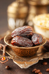Dry dates, crispy Ramadan dessert custard pudding with roasted kadayif and cup of coffee  for iftar time. Islamic religion and ramadan concept.