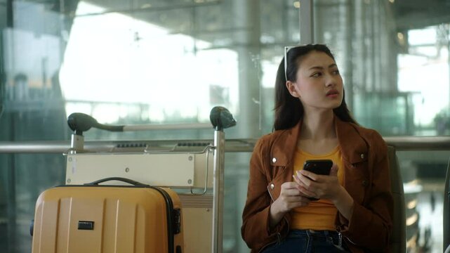 Unhappy young woman traveler disappointed with flight delay or cancelation while waiting at airport terminal, female tourist upset after receiving bad news when sitting at airline lounge.
