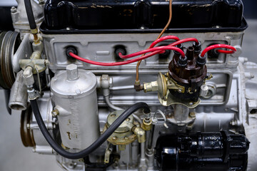 Fototapeta premium The engine of a mid-20th century truck with a carburetor and candles