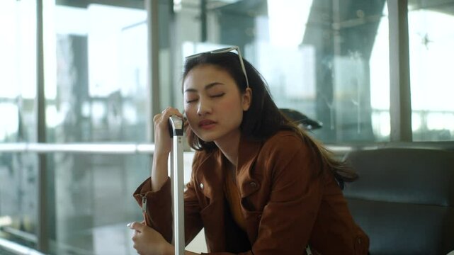 Unhappy young woman traveler disappointed with flight delay or cancelation while waiting at airport terminal, female tourist upset after receiving bad news when sitting at airline lounge.

