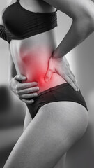 Fototapeta premium Grayscale image of a woman with highlighted red abdominal area, indicating lower belly pain or discomfort, symbolizing issues like cramps, indigestion, or other health concerns.