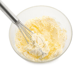 Bowl and whisk with delicious cream isolated on white
