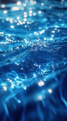 Rippling clear blue water reflecting light with splashes and bubbles during a bright daytime setting