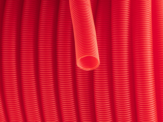 Plastic corrugated hose closeup. Red background.