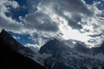 Majestic mountain peaks under dramatic clouds alpine region nature photography outdoor adventure scenic view natural beauty