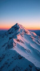 Snowy mountain peak touches darkening sky at dusk, alpine landscape, snowflakes