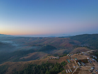 Aerial View of An image of sweet sky in sunrise above a valley of mist. High peaks wonderful morning sunrise nature Landscape. Beautiful sunset tropical landscape background.