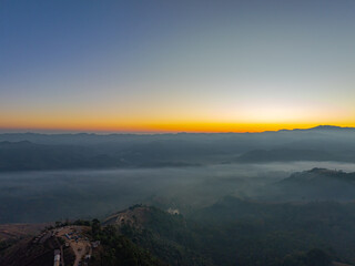 Aerial View of An image of sweet sky in sunrise above a valley of mist. High peaks wonderful morning sunrise nature Landscape. Beautiful sunset tropical landscape background.