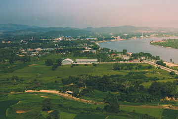 Naklejka premium Oxbow lake with green field, Chiang Rai, Thailand.