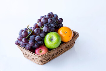 Assorted fresh mix fruits in a rectangle basket on white background, concept fruit in shop and supermarket..
