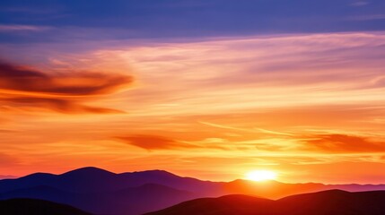 Obraz premium A breathtaking sunset over rolling hills, casting vibrant hues of orange, purple, and blue across the sky