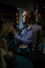 woman drinking coffee tea in book restaurant