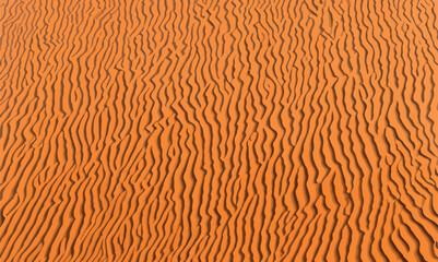 Desert background pattern, mountains border. Sand dunes background in aesthetic orange, yellow and beige colors. Sand simple and minimal background with photocopy space. Pattern, retro, dune, banner.