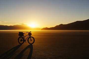 Fototapeta premium Sunrise bike ride, desert landscape, adventure travel