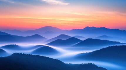 Obraz premium Mountain range with vibrant sunset sky and dramatic clouds in the background during twilight hours