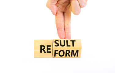 Reform and result symbol. Concept words Reform Result on beautiful wooden block. Beautiful white table white background. Businessman hand. Business Reform and result concept. Copy space.