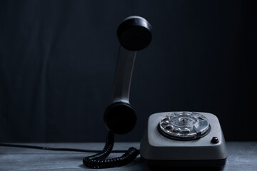 Retro telephone on black background. Vintage telephone.