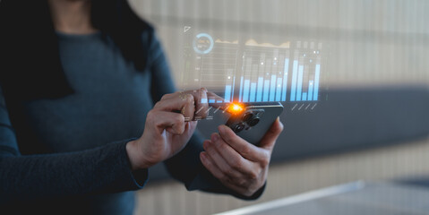 A person interacts with a futuristic smartphone displaying holographic data and analytics, highlighting advanced technology and digital innovation.