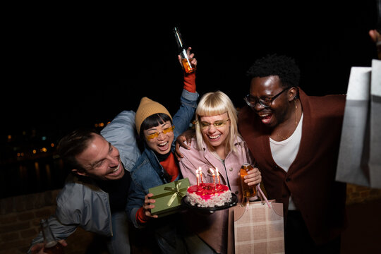 Group of Multi-Ethnicity people having fun outdoor in the night. Celebrate.