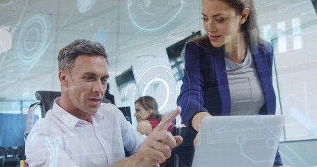 Analyzing data on laptop, business people with holographic charts image over office