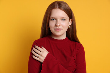 Fototapeta premium Teenage girl wearing stylish jewellery on yellow background