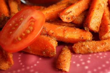 Tasty ketchup, tomatoes and fried carrots on plate, closeup